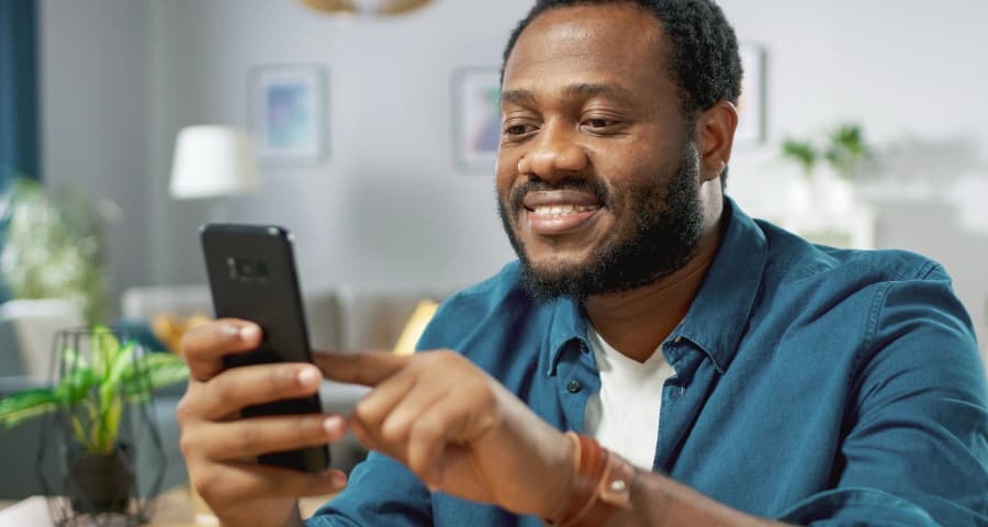 Man sitting down using an app on his phone